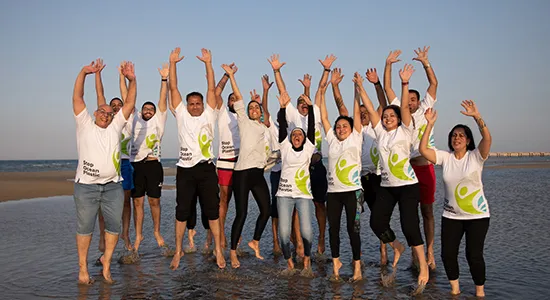 Plastic Bank Egypt team celebrating its 300 million bottle collection milestone in AlAin ElSokhna, located by the Red Sea.