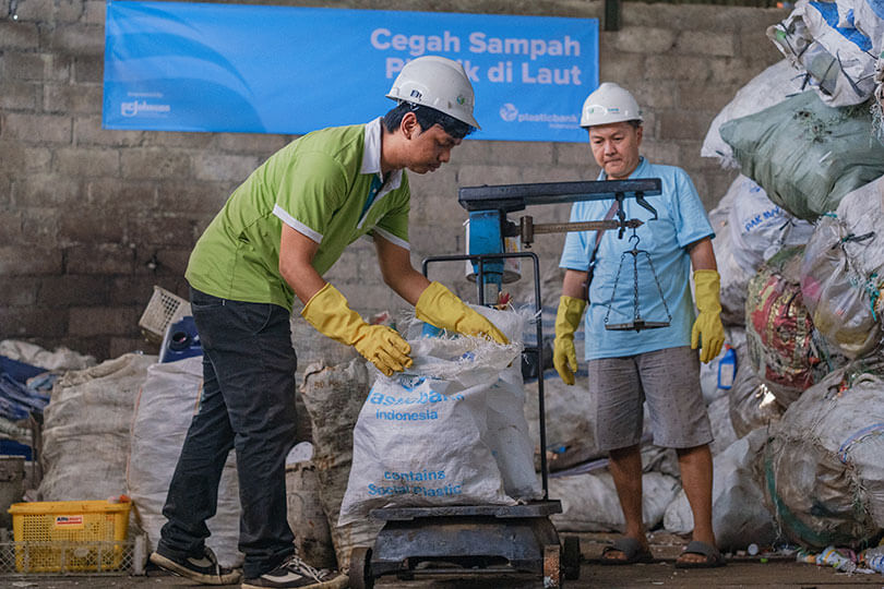 Weighing a sack of plastic bottles at Plastic Bank collection branch.