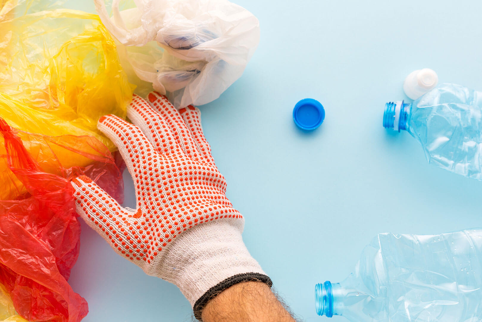 Worker sorting plastic garbage for recycling