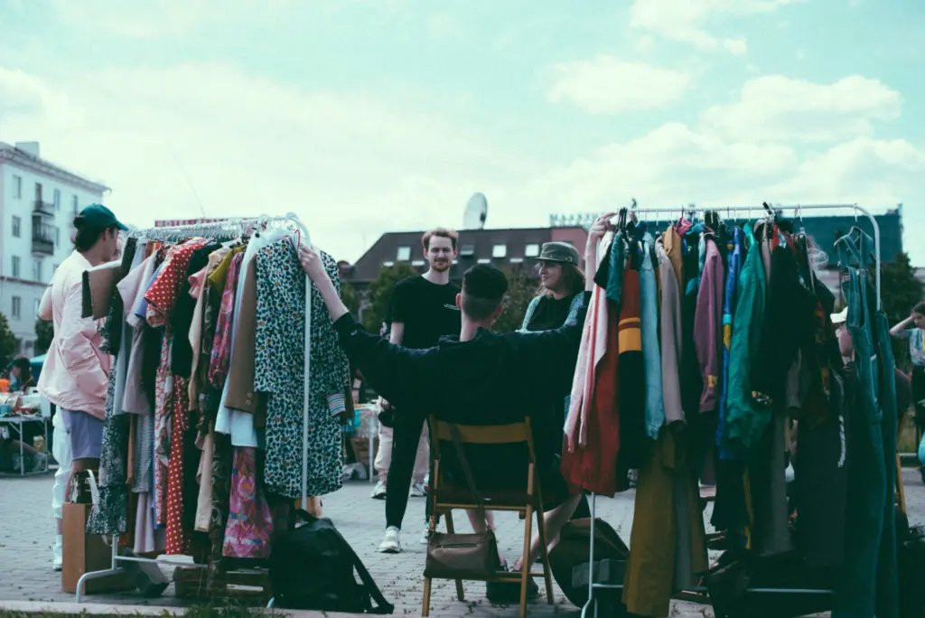 Secondhand clothes being sold on a sidewalk