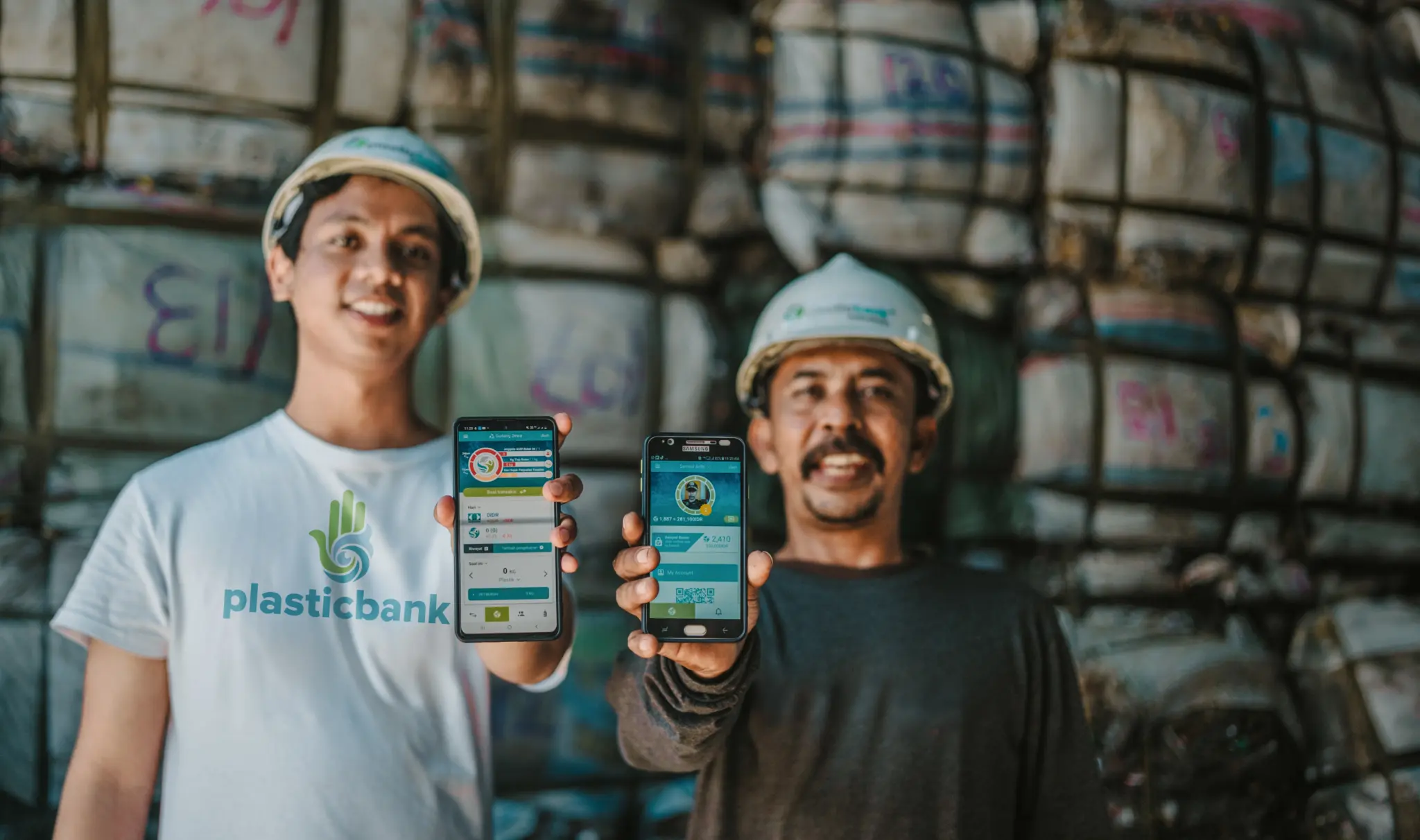 A Plastic Bank member and a collector showing the app they use to track collected plastic