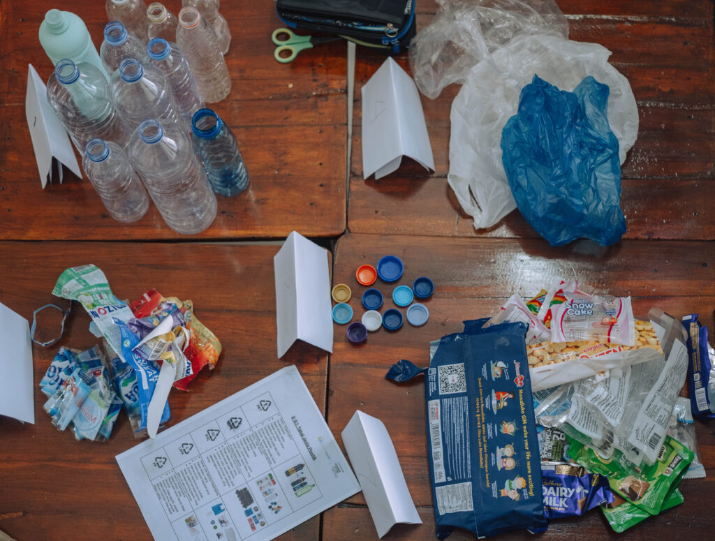 Different samples of plastic waste on a table separated by type