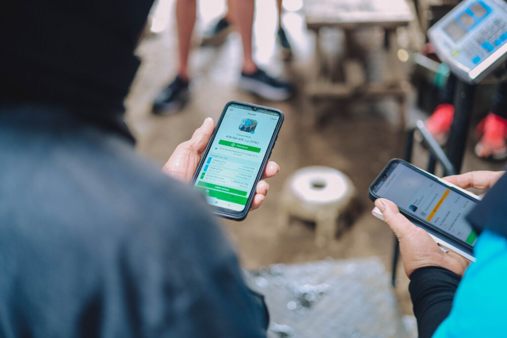 Two people using the Plastic Bank app