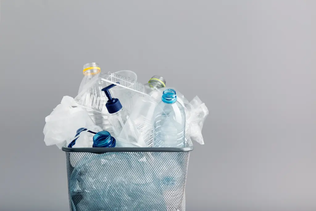 Clean plastic bottles in a metal trash bin